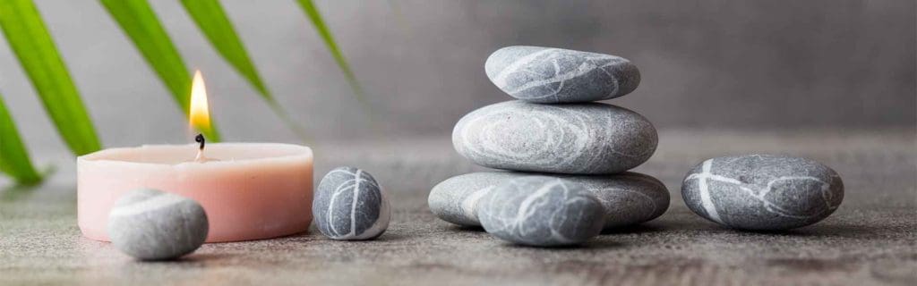 Stones and candles in a harmonious spa atmosphere, suitable for relaxation and wellness, perfect for a luxurious escort service experience.