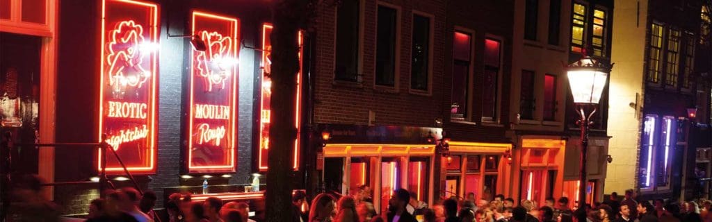 Erotic nightclub neon lights and partying people, attractive ladies in sexy outfits in the trendy district, ideal for escort service advertising.